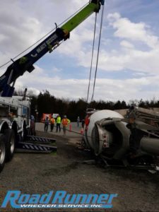 Heavy duty towing rotator provides crane service to lift cement mixer